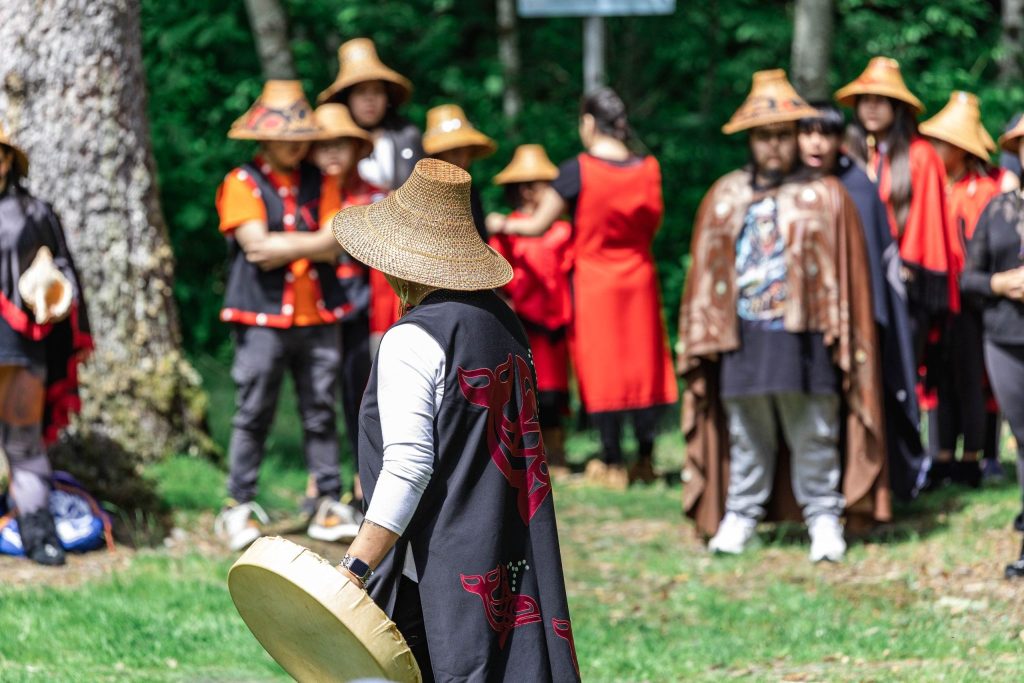 Drummers in cedar hats and regalia at National Indigenous Peoples Day in Kitimat